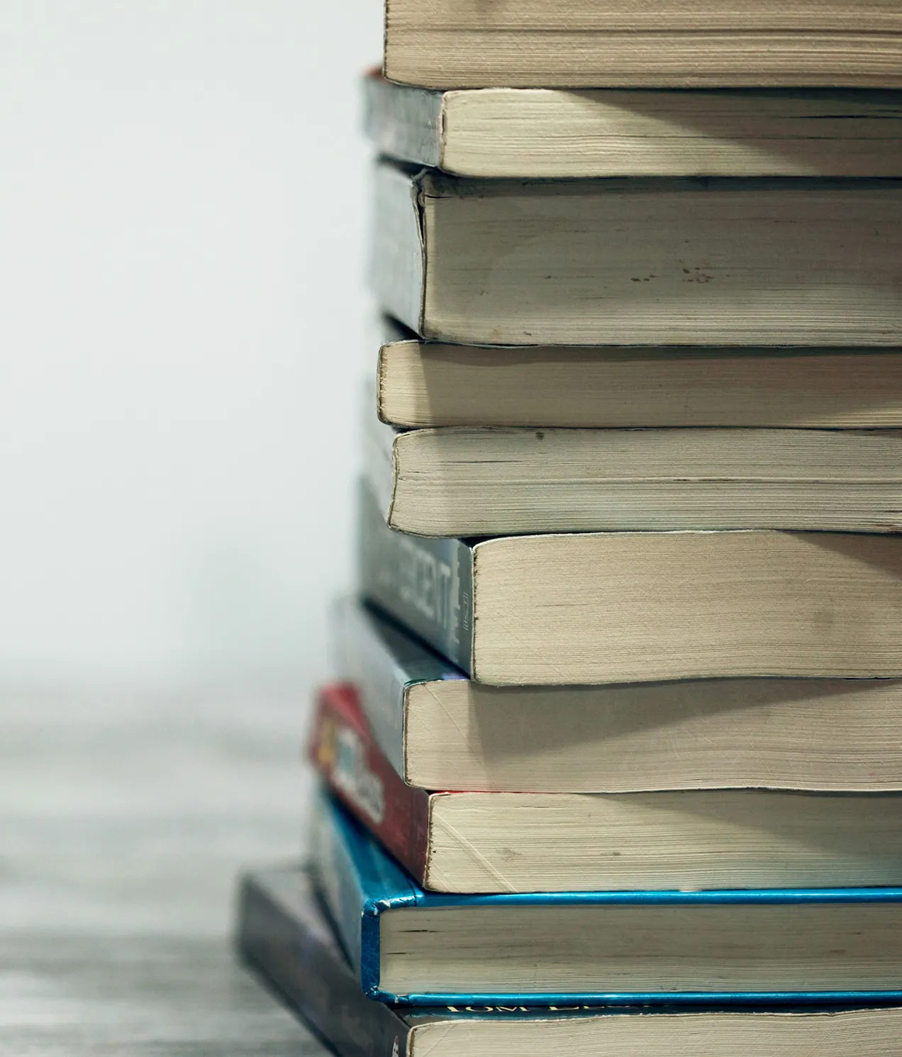 a stack of books viewed from the end with white background